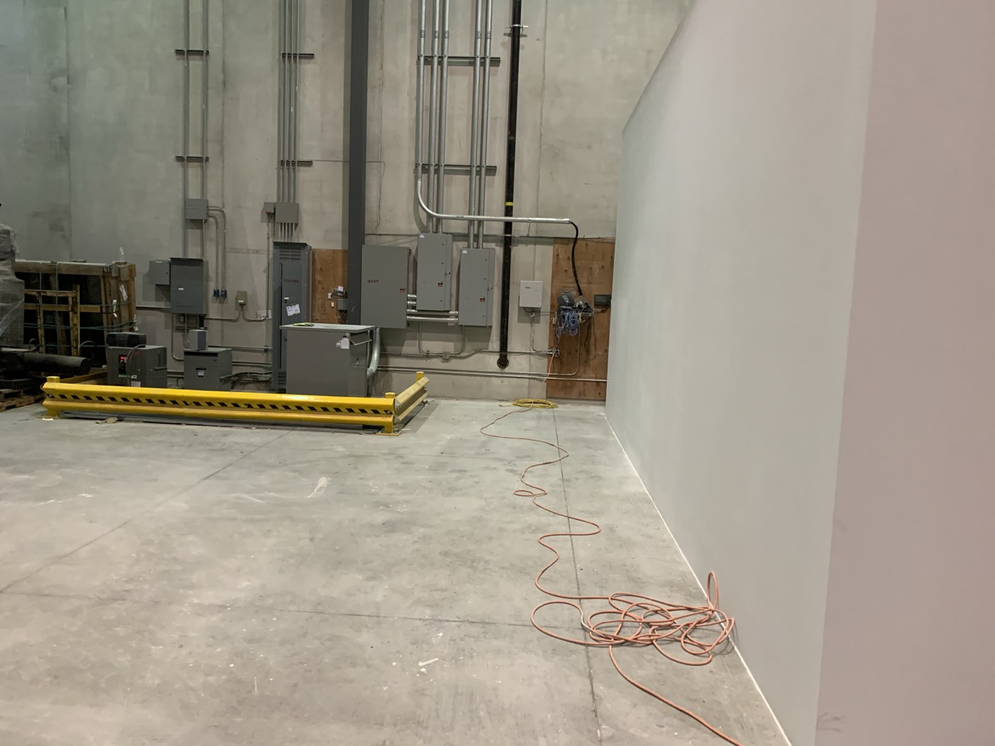 Distribution panels and conduit mounted in a commercial electrical room