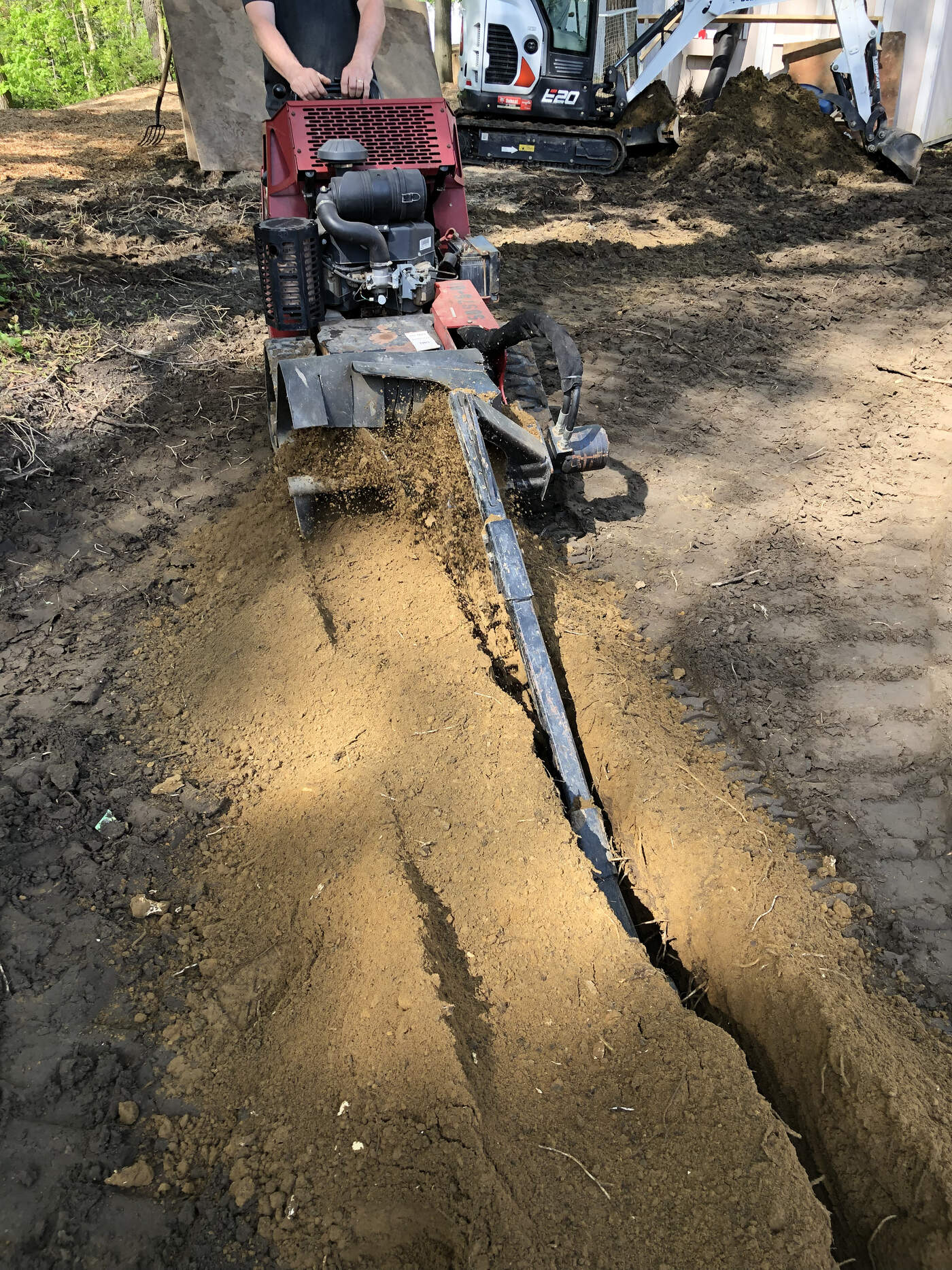 Walk-behind trencher cutting a trench for underground electrical service